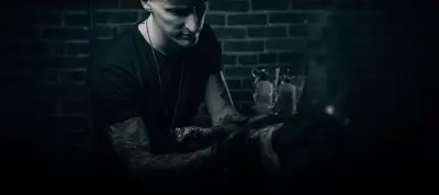 Andrew Stopay tattooing in his studio